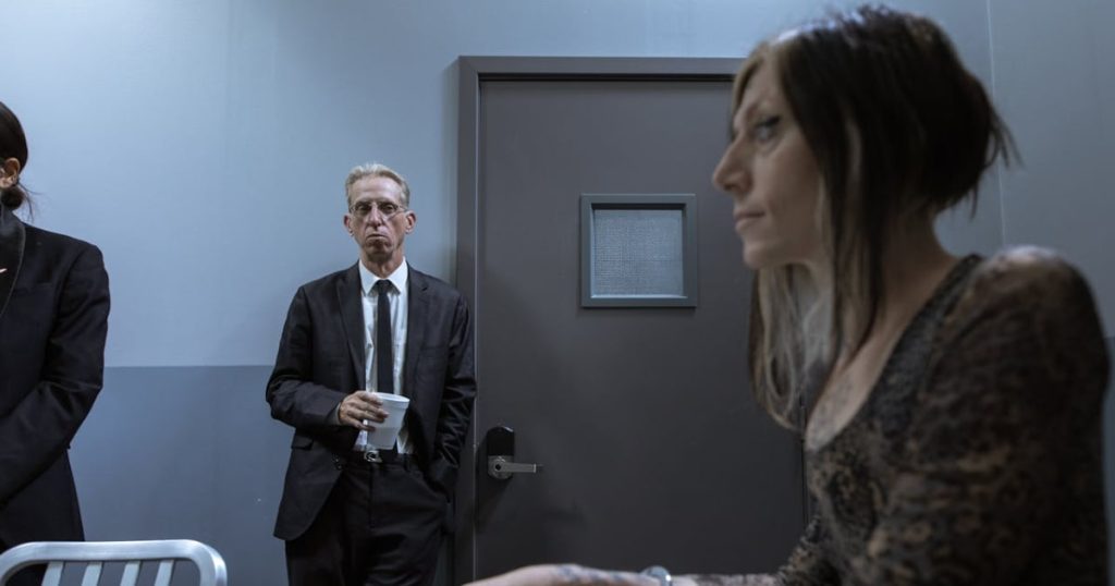Woman getting interrogated by police detectives.